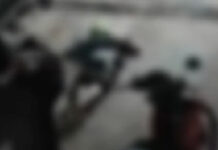Atirador tenta fugir empurrando moto após a execução na borracharia